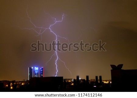 Storm over the night skyline of Madrid (skyscrapers and lightning).