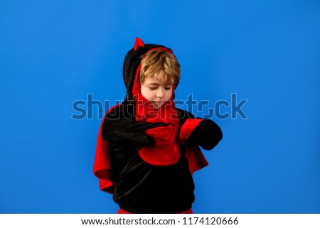 Small boy celebrating halloween in carnival costume. Cute child dressed as dragon. Trick or treat. Halloween party. Holiday, festival, carnival, celebration. Boy in cute monster costume for Halloween.