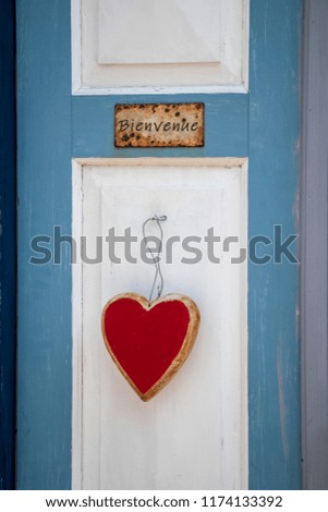 Welcome sign on a blue white door