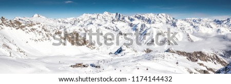 Skiers skiing on the top of Presena Glacier, Tonale, Italy.