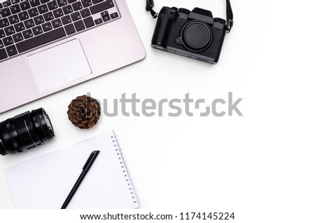 Stylish photo camera, lens, cone, notepad and pen on white background. Flat lay, top view. Freelance or online education concept.