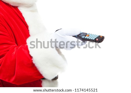 Christmas. Close-up. Santa Claus in white gloves holding the TV remote control. Browse Christmas TV listings, select the channel. Isolated on white background.
