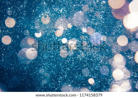 Underwater bubbles with sunlight through water surface, natural scene