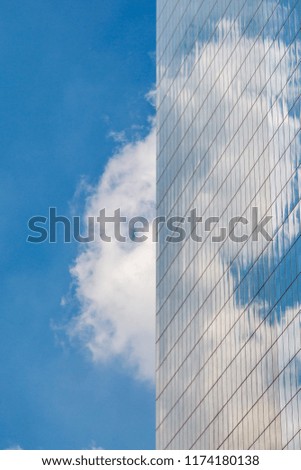 Looking up at cloud reflections in skyscraper windows