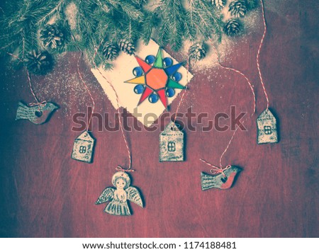 christmas background / figures of houses, deer, snowman ,angel and paper cut snowflakes on the blue  wooden background