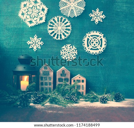 christmas background / figures of houses, deer, snowman ,angel and paper cut snowflakes on the blue  wooden background
