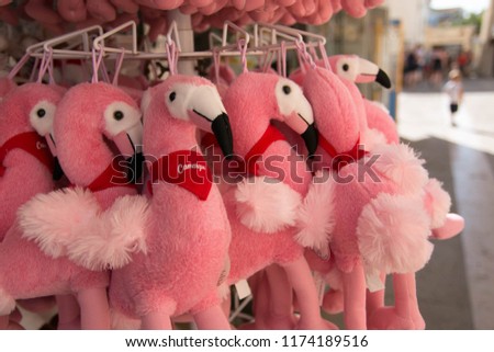 Flamingo plush toys with the word "Camargue" written on them, on sale outside a shop in Saintes Marie de la Mer, Camargue, France. Close up.