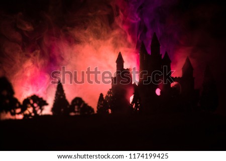 Mysterious medieval castle in a misty full moon. Abandoned gothic style old castle at night. Selective focus