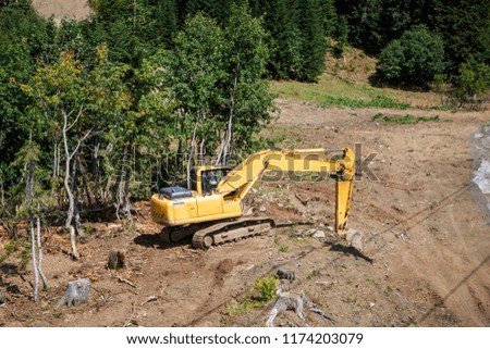 Photo of working excavator on summer day