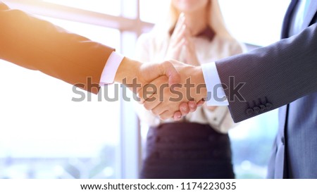 Business people shaking hands as a sign of agreement. Success concept