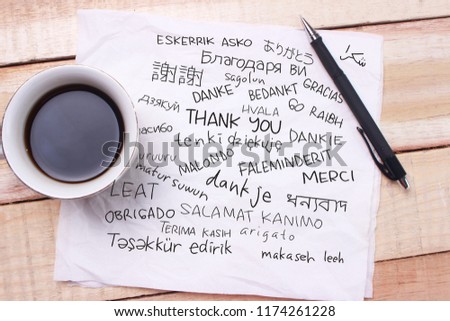 Thank you gratitude words letter in many languages, written on notepad, work desk top view. Motivational business typography quotes concept 