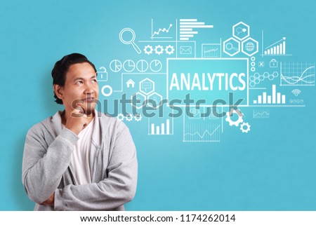 Business Concept. Smiling happy successful young asian male entrepreneur with analytics words on virtual screen. Modern Text typography design