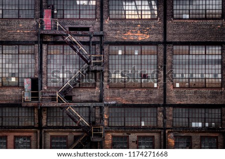 A fire escape on an old brick building in urban landscape. Royalty-Free Stock Photo #1174271668