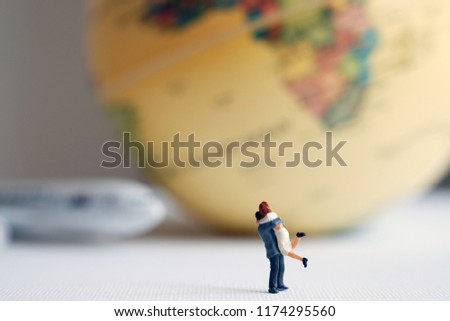 miniature couple with world map and a plane ,Image for Love couple concept and 
Couple travel concept.