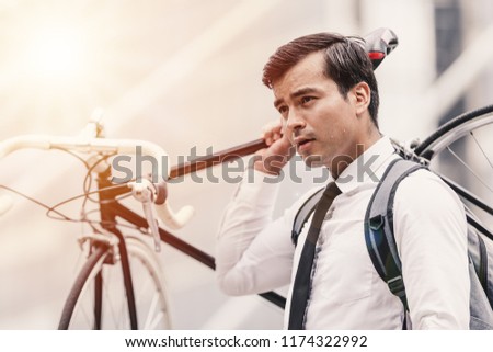 Business man worker carrying bicycle in city,Concept ecology bike go to worker Royalty-Free Stock Photo #1174322992