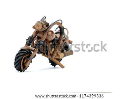 Motorcycle toy in brown and black colour texture isolated on white background, with wooden handmade. 