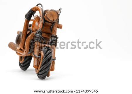 Motorcycle toy in brown and black colour texture isolated on white background, with wooden handmade. 