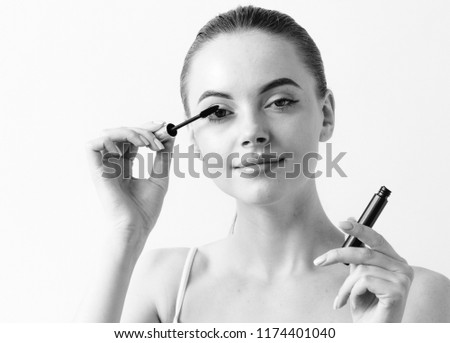 Mascara woman applying makeup monochrome