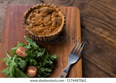 Stuffed pie on a wooden background.