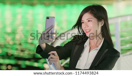 business woman take phone selfie happily at night