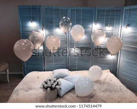 A beautiful room decorated with helium balloons of pink and white colors. Professional design. Modern, stylish and festive