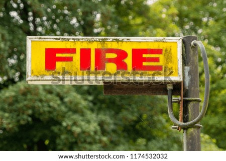 Fire sign with patina and old pole