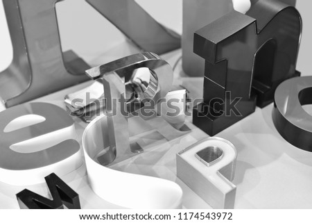 metal letters in different forms in black and white photo