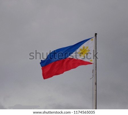 National flag waving in the sky at downtown in Manila, Philippines.