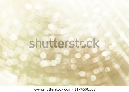 Abstract white bokeh texture on blurred gold colour background, decoration for desktop. 