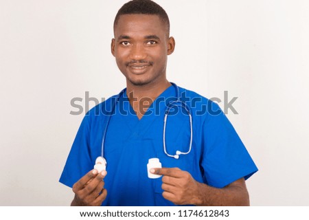 young smiling dermatologist is holding and showing medical cream for skin