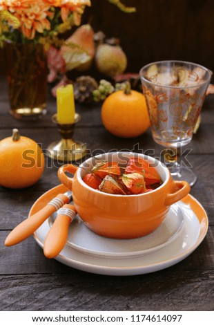 autumn table setting with pumpkin and flowers