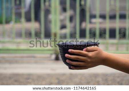 Young boy homeless holding ceramic plate with hungry and need food. Homeless concept. 