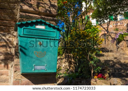 Traditional green mail box on the wall at the entrance to private house in Spain.