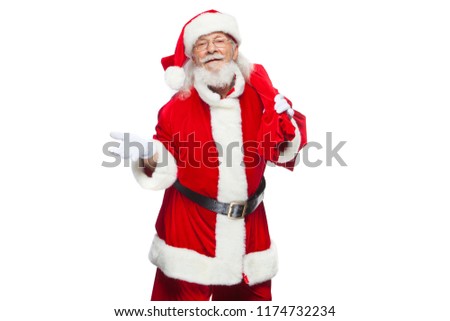 Christmas. Santa Claus is suffering from back pain and holds a red bag with gifts on his back. Isolated on white background.