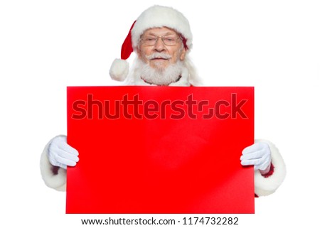 Christmas. The kind Santa Claus in white gloves holds an empty cardboard of red color. Place for advertising, for text, empty space. Copy-paste. Isolated on white background.