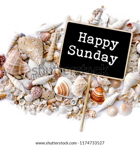 Happy Sunday word on sea shells and blackboard