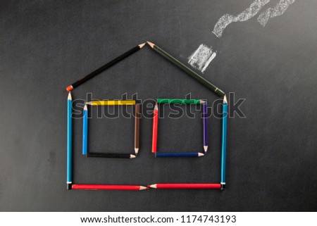 The shape of the house with pen on a chalkboard