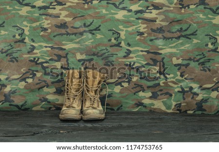 old  military boots on a wooden table