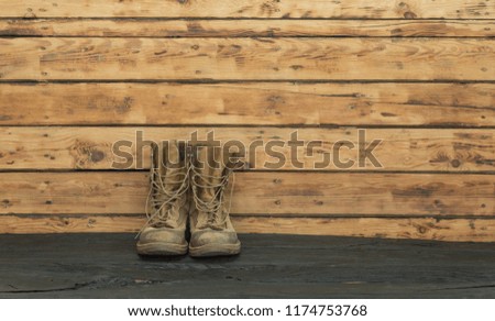 old  military boots on a wooden table