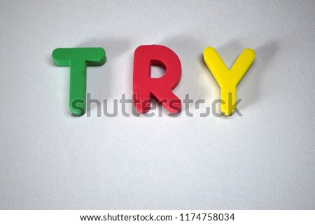 Word TRY from colorful 3D foam letters on white background
