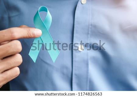 Prostate Cancer Awareness, Man holding light Blue Ribbon for supporting people living and illness. Men Healthcare and World cancer day concept Royalty-Free Stock Photo #1174826563