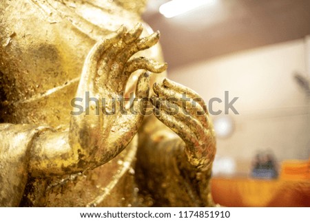 The golden Buddha statue.View of buddha statue in Thailand.Close up hand of statue Buddha.buddhism concept