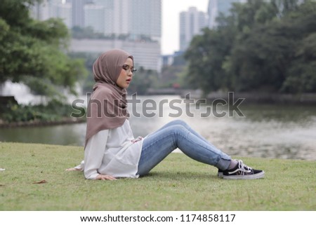 Cute little girl wearing hijab casually as personal style in the morning at the park.