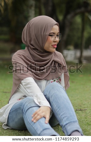 portrait of a girl wearing light chocolate color hijab in the morning at park