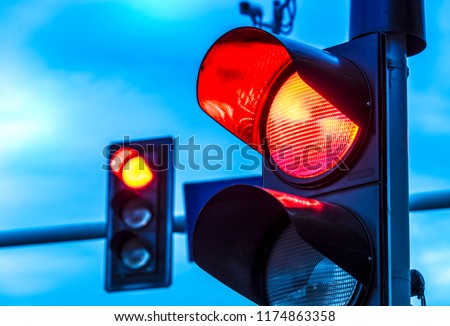 Traffic lights over urban intersection. Red light Royalty-Free Stock Photo #1174863358