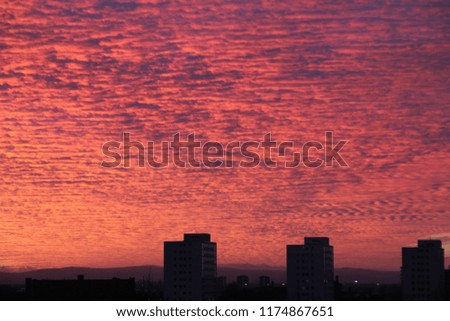 Red cloud above city