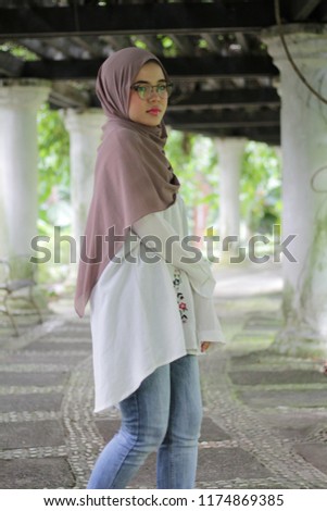 Beautiful cute  young girl with hijab. Hijab style fashion. In the park early in the morning.