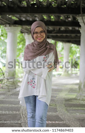 Beautiful cute  young girl with hijab. Hijab style fashion. In the park early in the morning.