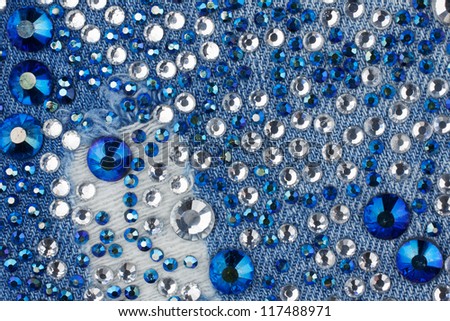 Light-blue denim with blue and silver rhinestones, background Royalty-Free Stock Photo #117488971