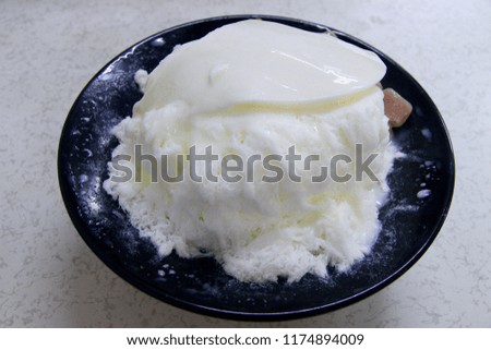 A bowl of almond shaved ice with condensed milk